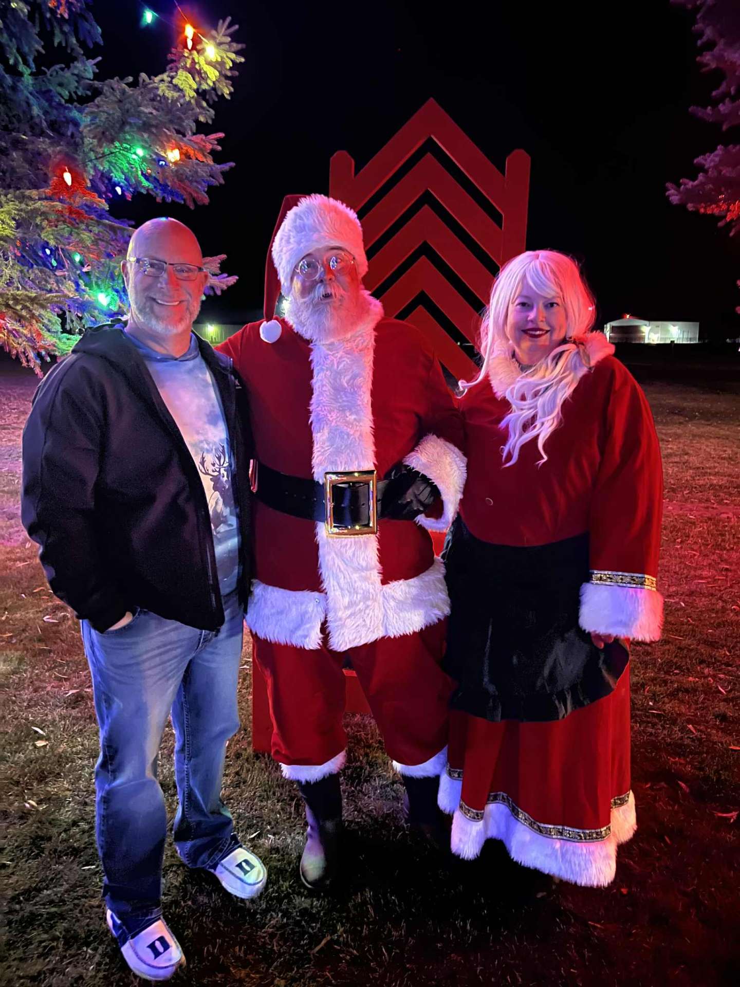 Owner Erik with Santa and Mrs. Claus at a holiday lighting event