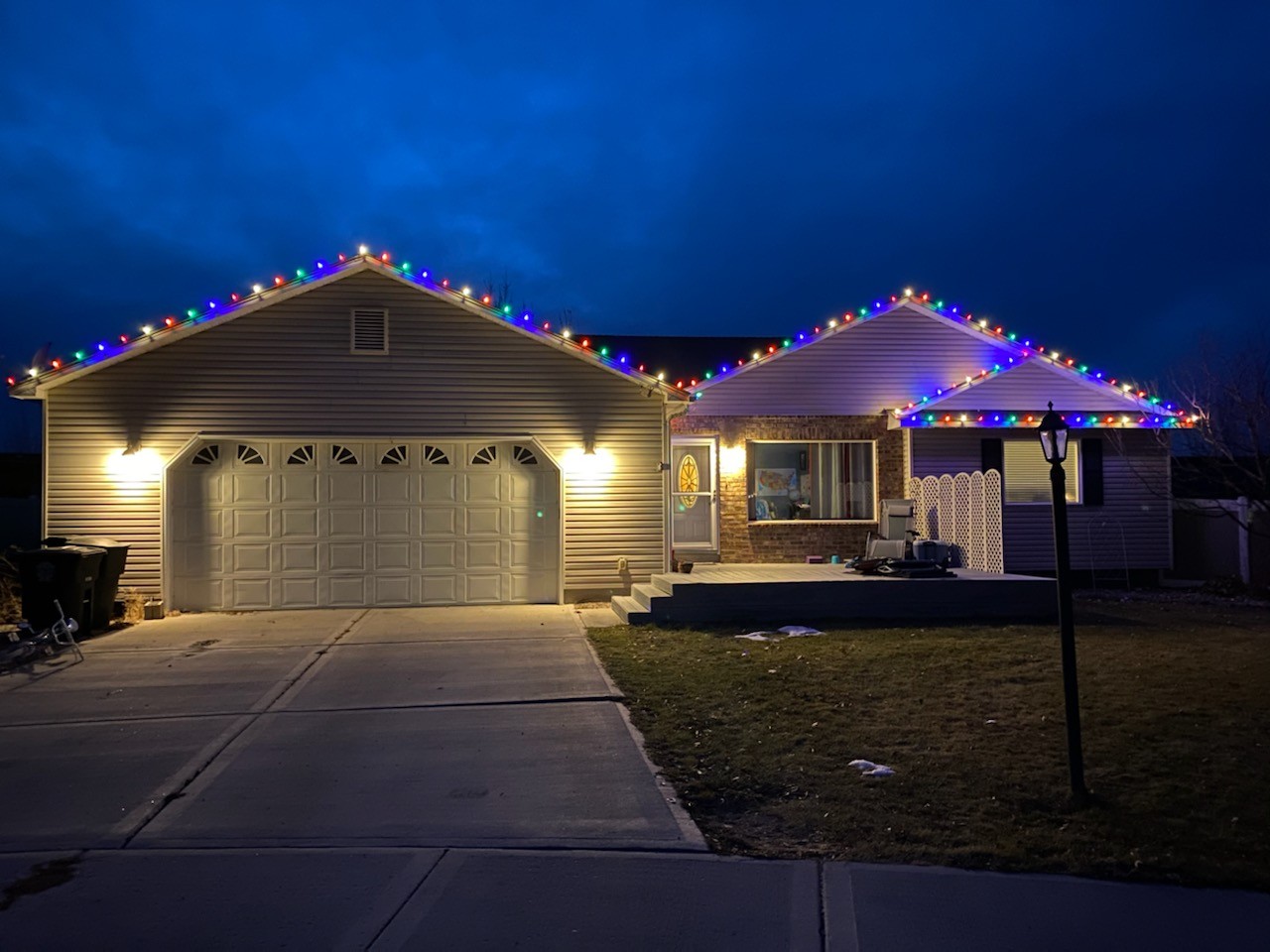 Pocatello home with multi-color Christmas roofline lights