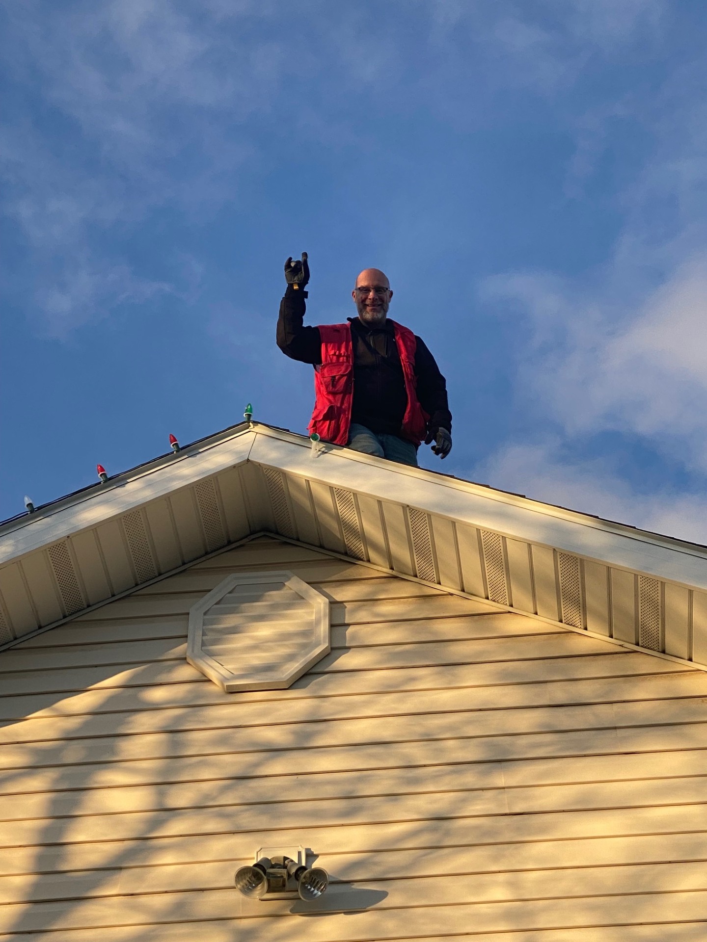 Santa's Magical Lights installer on rooftop
