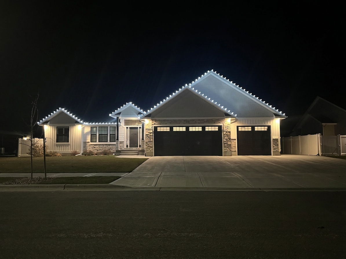 Rexburg home with cool white Christmas roofline lights